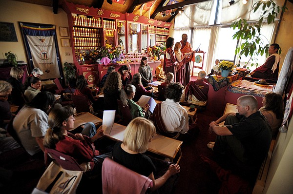 Georgia Milan of Florence, standing left to right, Christ Riebe of Arlee, and John Schumpert of Missoula, take part in a Tibetan Buddhist ceremony on Sunday at Ewan Montana in Arlee.