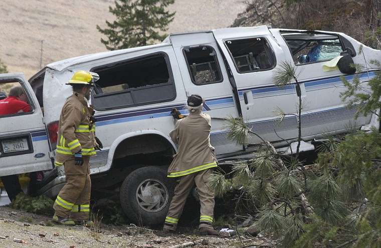 &lt;p&gt;Plains-Paradise Rural Fire Department firefighter Pat Erving pries the doors open of a van that crashed into the embankment on Highway 28.&lt;/p&gt;