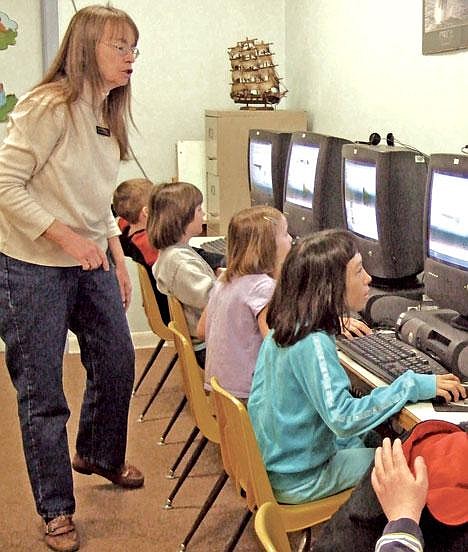 Asa Wood Elementary School teacher's aide Deanna Byrer works with students. Byrer has served more years than any other aide in Libby and possibly Montana.