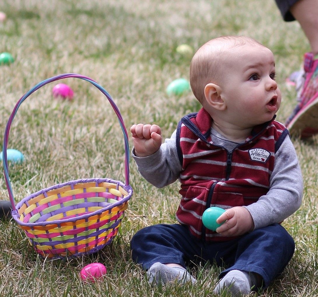 <p>Ten month old, Liam Worcester, looks befuddled at all the egg hunting activity in Eva Horning Park in Superior on Saturday</p>