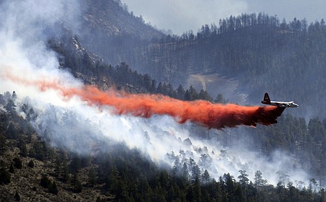 &lt;p&gt;A slurry bomber drops retardant on the Lower North Fork Fire in Jefferson County, Colo., Tuesday, March 27, 2012. Investigators were trying to determine whether a controlled burn designed to minimize wildfire risk reignited and became a stubborn mountain wildfire that forced hundreds of residents to flee their homes and may have caused the deaths of two people. (AP Photo/The Denver Post, RJ Sangosti)&lt;/p&gt;