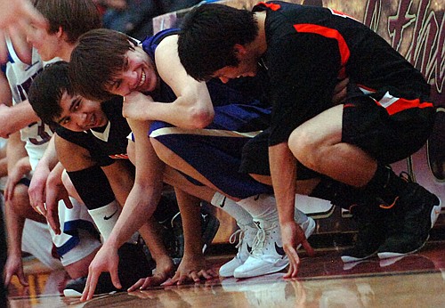 Ronan and Polson players share a laugh on the sidelines.