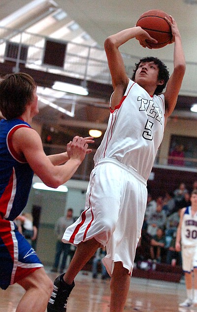 TJ Cutfinger takes a jumpshot over a Bigfork defender.