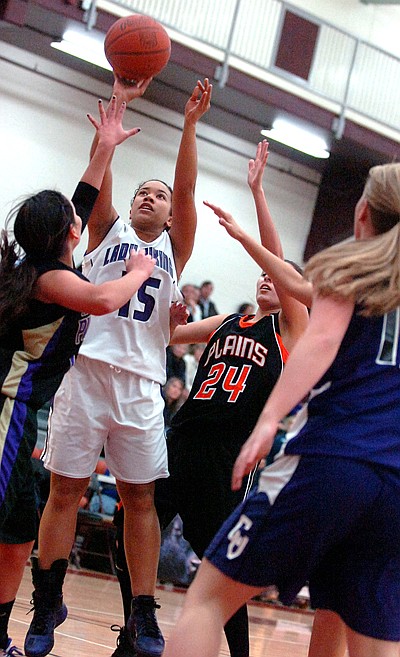 Despite being under heavy pressure, Charlo's Deondra Brown puts up a shot.