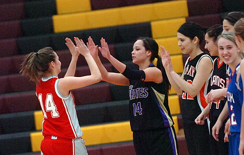 Arlee's Whitney Malatare gets a high five from Polson's Mariah Hamel.