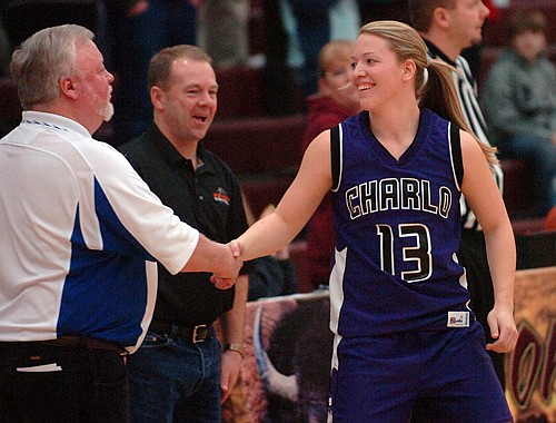 Charlo's Kinley Pope gets a hand shake from Mission's Lloyd Phillips.