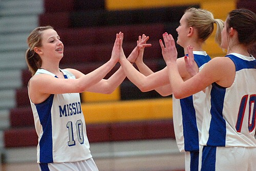 Stephanie Lewandowski gets high fives from her Mission teammate Loren Erickson.