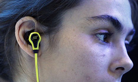 &lt;p&gt;A model wears SMS Audio BioSport In-Ear Headphones at the Intel booth during the International CES, in Las Vegas, Jan. 6.&#160;&lt;/p&gt;