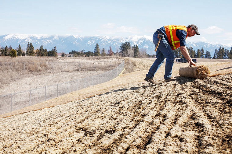 &lt;p&gt;Neil Creighton of Agro Tech unrolls an erosion-control blanket Tuesday afternoon on a hill along Hutton Ranch Road behind Hutton Ranch Plaza. The blankets, made of a mixture of straw and shredded coconut, are helping prevent the erosion of a berm directing runoff water to the proper retention pond. Tuesday, March 26, 2013 in Kalispell, Montana. (Patrick Cote/Daily Inter Lake)&lt;/p&gt;