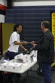 Mahalia Harris of the Plains Drama Club sells Krispy Kreme donuts on Saturday at the trade fair. Harris is a member of the club which was selected to compete at the national event after their performance of &quot;Our Diamond.&quot;