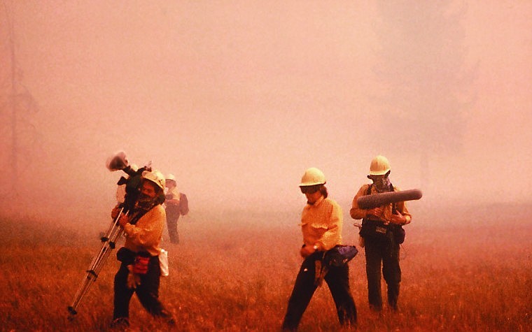 Vanderbilt escorts David Dow and a CBS News crew from a burning field at Old Faithful in Yellowstone Park on Sept. 7, 1988. The next year Vanderbilt went to work in Glacier National Park.