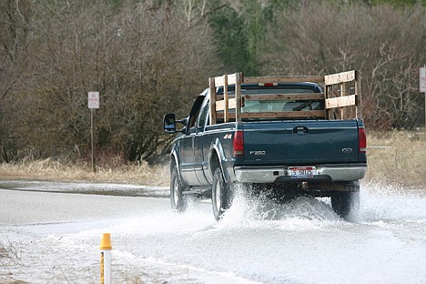 &lt;p&gt;A truck takes on water-covered Latour Creek Road in Cataldo on Saturday afternoon. Water levels are projected to drop through Monday, depending on the weather.&lt;/p&gt;