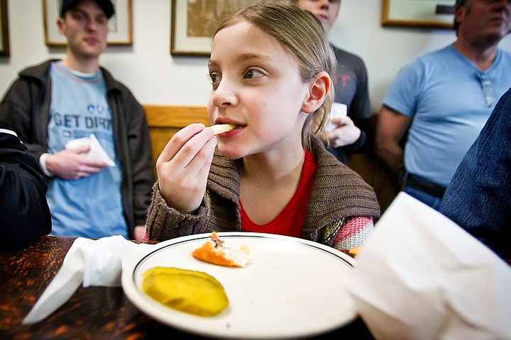 &lt;p&gt;Adelynn Smart, 8, eats a french fry after finishing her hamburger Thursday at Hudson's in downtown Coeur d'Alene. The popular eatery was subject to an April Fool's Day prank in which 25 orders of french fries were delivered to their customers by Bonsai Bistro chef Troy Chandler since they have never had fries on their menu.&lt;/p&gt;