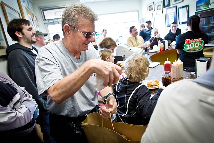 &lt;p&gt;Rick Halberg, with Cafe Courier, delivers 25 orders of french fries to Hudson's Hamburgers customers.&lt;/p&gt;