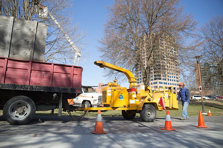 &lt;p&gt;City Worker, Darrell Brunetti shoves branches into a wood chipper as Nick Goodwin prunes a tree to get the area ready for spring on Wednesday near the public library in Coeur d'Alene.&lt;/p&gt;