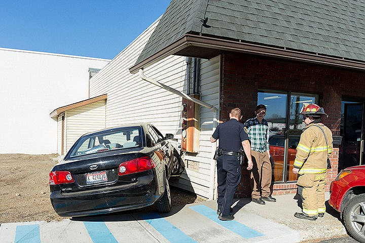 &lt;p&gt;An officer with the Coeur d&#146;Alene Police Department and a firefighter with the Coeur d&#146;Alene Fire Department speak with the elderly driver of a mid-size sedan that crashed into Cedar Mountain Supply near Government Way on Monday. After complaints of neck pain, one woman was transported to Kootenai Health as a precaution.&lt;/p&gt;