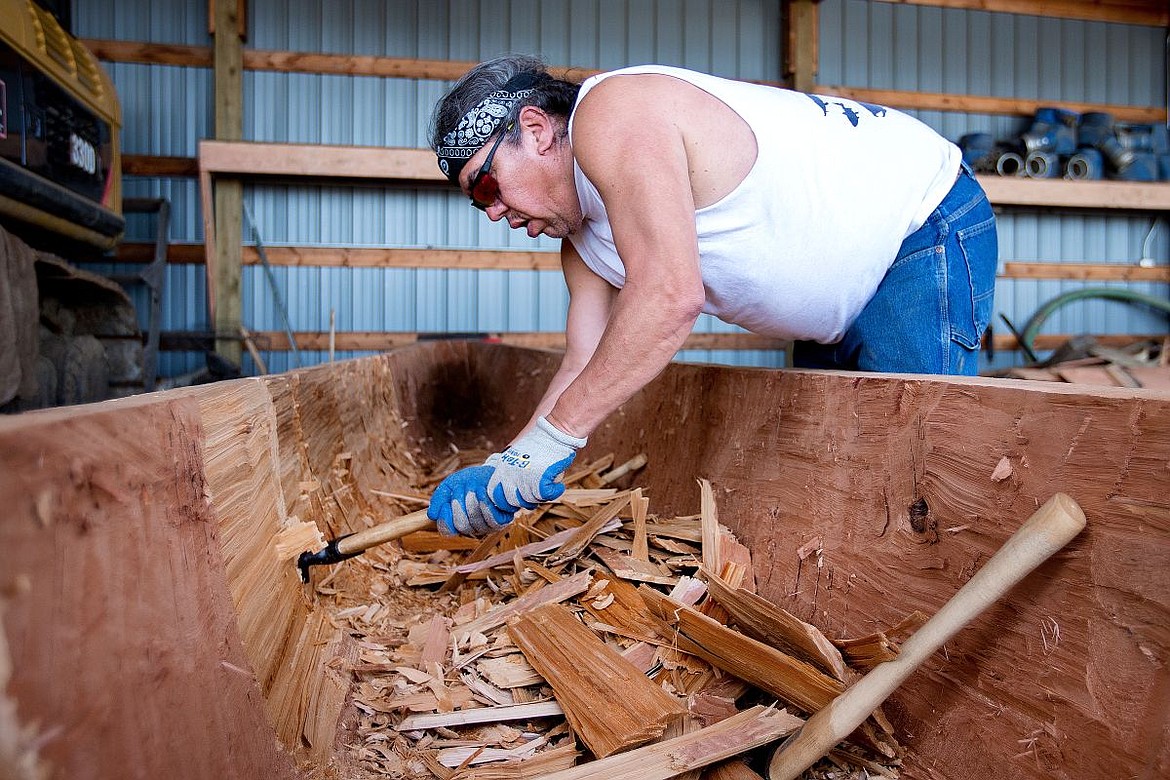 &lt;p&gt;Sile' Mark H. Stranger, a Coeur d'Alene Tribe elder, shears chips of wood from the interior of what will be a 34-foot-long canoe on Thursday in Plummer. The tribe was gifted a 700-800-year-old old-growth tree log to bore out, by hand, a traditional canoe.&lt;/p&gt;
