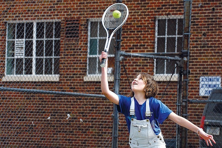 Eilee Crusta, 12, connects with the ball while playing a game of doubles tennis with friends on the tennis courts next to the Museum at Central School in Kalispell Monday afternoon.