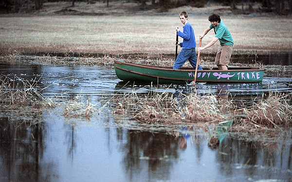 Brenda Ahearn/Daily Inter Lake
Mathew Gutierrez, left, and Kristian Stipe, both 16, of Whitefish, take a small boat out onto a run off puddle on Tuesday north of Whitefish. Gutierrez said this was the first time they had been out on the puddles this year.