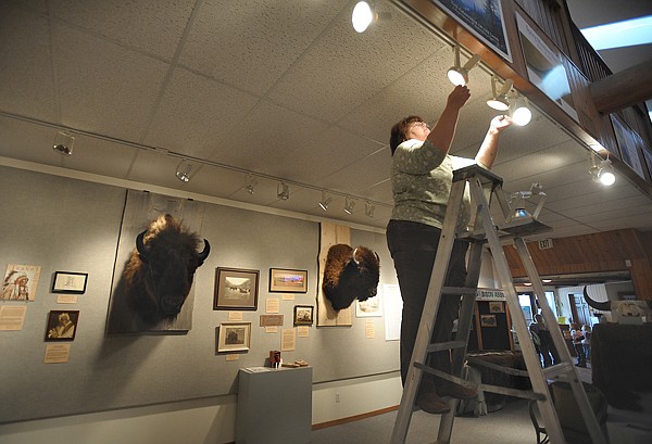 Brenda Ahearn/Daily Inter Lake
Marnie Forbis, director of the Bigfork Museum of Art and History, hanging lights on Wednesday in preparation for today's opening of the new show &quot;The American Bison in Montana Art and Culture. There will be a reception tonight from 5 to 7 p.m. The show will run until the end of the month.