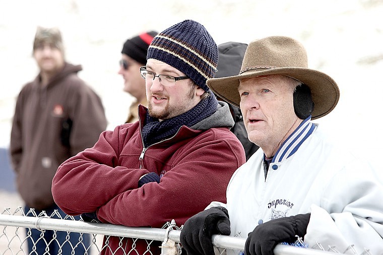 <p>Nicholas Schwaderer converses with former District 14 Representative Gordon Hendrick during the Superior Bobcat semifinal football game.</p>
