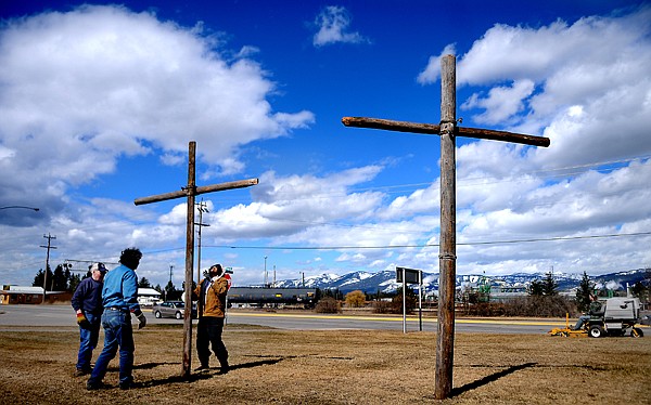 &lt;p&gt;From left, Dick Daniels, Ron Corcoran, and Margaret Baylinson, all members of the church and from Columbia Falls, work together to raise crosses in front of Saint Richard's Catholic Church on Tuesday afternoon, March 27, in Columbia Falls. The three crosses have been raised along Highway 2 for the past five years. They go up the week before Palm Sunday and are taken down after Pentecost, fifty days after Easter Sunday.&lt;/p&gt;