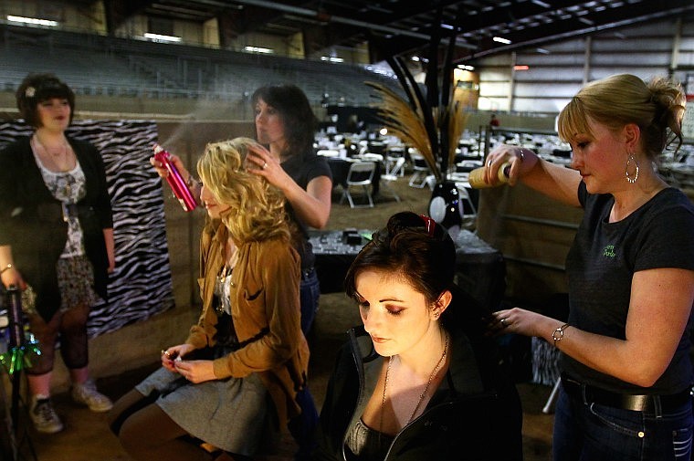 Kacie Hall closes her eyes while Victoria Enger sprays her hair two hours before the start of Friday evening&#146;s show. To the right, Nicole Croteau (blonde) gets her hair styled by Jesi Remp while Nicole&#146;s sister, Olivia Croteau looks on.