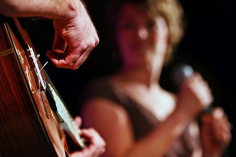 Heidi Bain looks on before starting to sing her song as her guitarist Paul Gonsorchik moves his fingers over the strings.