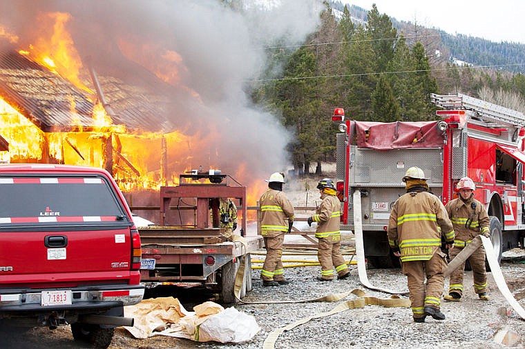 <p>Fire crews unroll hoses at the scene of a house fire Friday morning on Truman Creek Road near Kila . April 4, 2014 in Kila, Montana. (Patrick Cote/Daily Inter Lake)</p>