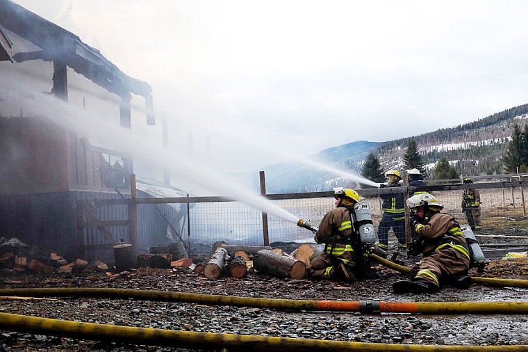 <p>Fire crews respond to a fully-engulfed home Friday morning on Truman Creek Road near Kila . April 4, 2014 in Kila, Montana. (Patrick Cote/Daily Inter Lake)</p>