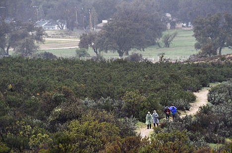 &lt;p&gt;Hikers Shawn Forry, front, and Justin Lichter, along with some friends, walk the final section of the trail to the southern terminus of their historic journey on the Pacific Crest Trail at the Mexican border near Campo, Calif., on March 1.&lt;/p&gt;