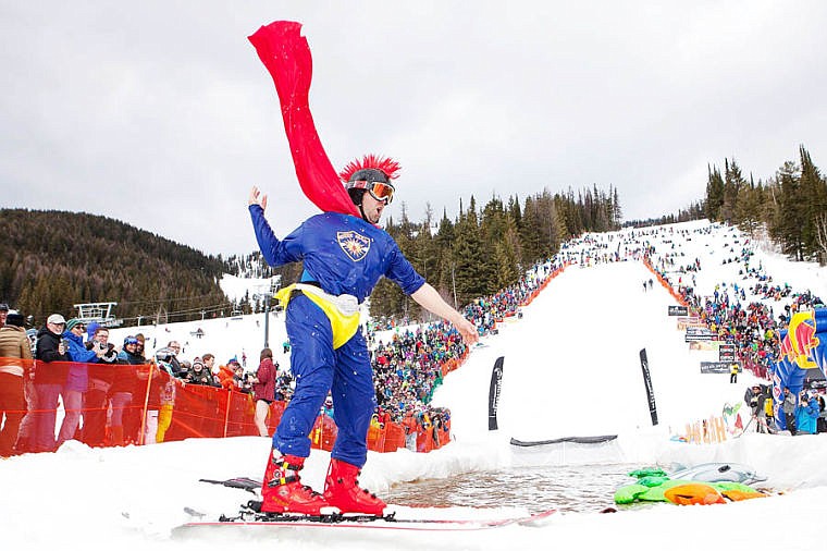 <p>Barton Slaney, dressed as "The Beerman," throws back his cape after a successful run Saturday afternoon during the 9th Annual Whitefish Mountain Resort Pond Skim. April 5, 2014 in Whitefish, Montana. (Patrick Cote/Daily Inter Lake)</p>