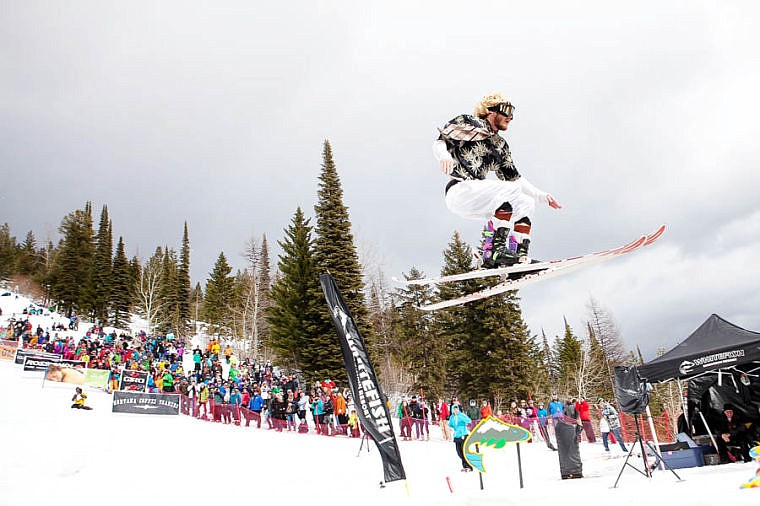 <p>Pond skim champion Tyler Slaney flies through the air on his winning run Saturday afternoon during the 9th Annual Whitefish Mountain Resort Pond Skim. April 5, 2014 in Whitefish, Montana. (Patrick Cote/Daily Inter Lake)</p>
