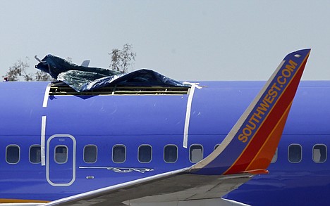 &lt;p&gt;A Southwest Airlines plane sits in a remote area of the Yuma International Airport on Monday, after the plane had a section of fuselage tear from the plane during a flight on Friday. Three more Southwest Airlines jetliners have small, subsurface cracks that are similar to the ones suspected in the fuselage tear on the plane shown. Federal aviation officials are considering an order for other airlines to inspect their aircraft.&lt;/p&gt;