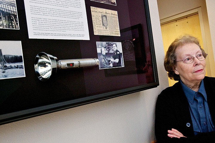 &lt;p&gt;Mary Button stands alongside the display case holding the flashlight her late husband, Harry Button, used after falling into the Spokane River when the Spokane River bridge collapsed March 27, 1971. The historical items from that event are displayed in the Post Falls Police Department where Button volunteers.&lt;/p&gt;