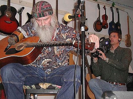 John Twiggs, producer of "Backroads of Montana" films Troy-area guitarist Alan Lane at Northwest Music Hot Club Coffee House in Troy. The business, which features live music in a non-smoking and non-alcoholic environment, will be featured on the PBS television show.