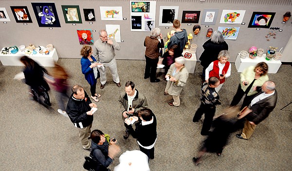 <p>Students, teachers and staff from area schools and members of the public walk through the gallery show at An Evening of Fine Arts at the Arts and Technology building at Flathead Valley Community College on Tuesday night, April 3, in Kalispell.</p>