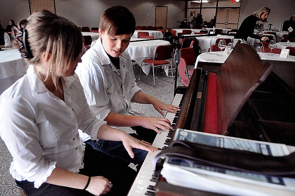 <p>Hannah Hickethier and Jack Desmul of Kalispell Middle School warm up before for the start of the musical acts at An Evening of Fine Arts at the Arts and Technology building at Flathead Valley Community College on Tuesday night, April 3, in Kalispell.</p>