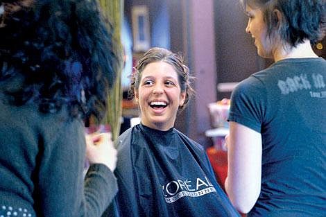 Sam Tartaglino shares a laugh with a friend while getting ready for the Flathead HIgh School prom on March 29. Stylist Miranda Peterson, right, did Tartaglino&#146;s hair and makeup. Michael Richeson/Daily Inter Lake