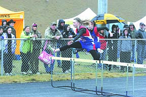 Nicole Stroot leaps over a hurdle at the track meet on Saturday.