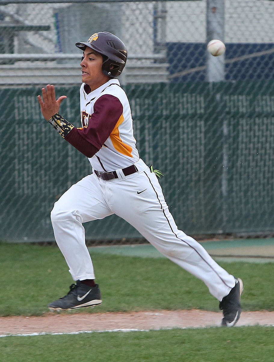 Pinch-runner Daniel Ochoa races the ball home in the eighth inning against Sunnyside. Ochoa beat the throw home to score the winning run.