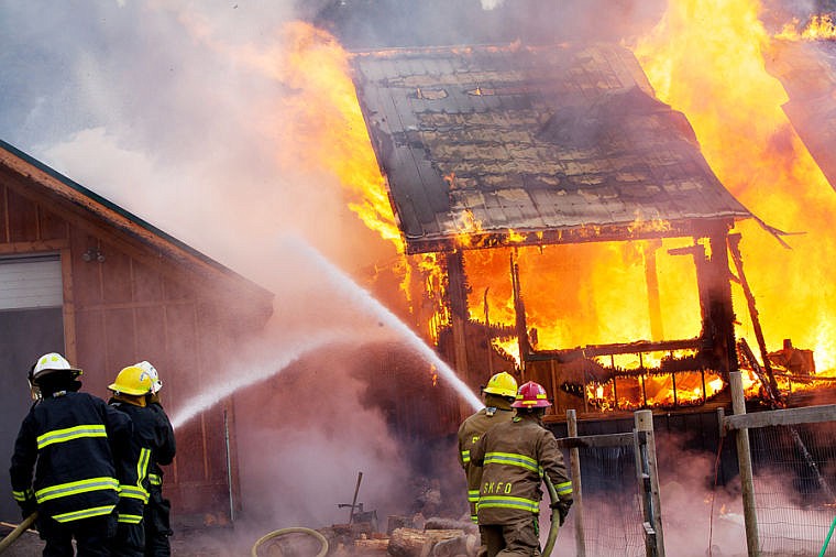 &lt;p&gt;Fire crews respond to a burning home Friday morning on Truman Creek Road near Kila. (Patrick Cote/Daily Inter Lake)&lt;/p&gt;