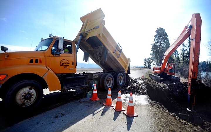 &lt;p&gt;Thirst trucks will bring 10 cubic yards each of fill&#160;material to deal with the hole forming on the west side of Columbia Falls Stage Road. Construction began on Wednesday, April 2, east of Kalispell and continues today. (Brenda Ahearn/Daily Inter Lake)&lt;/p&gt;