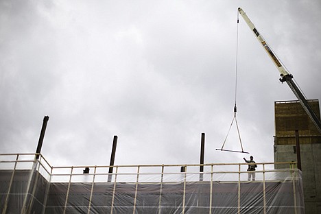 &lt;p&gt;A worker guides a bundle of rebar to the roof of construction project that will house physicians offices as part of a Kootenai Health expansion, a plan to accommodate future health care needs.&lt;/p&gt;