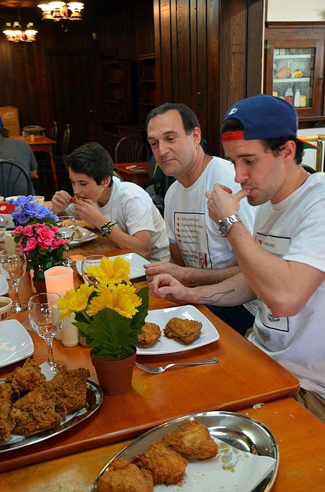 <p>Brian Lutfy, center, his son, Jason, left, and stepson Sebastien, of Montreal, enjoy original Kentucky Fried Chicken at the Harland Sanders Cafe and Museum in Corbin, Ky. </p>