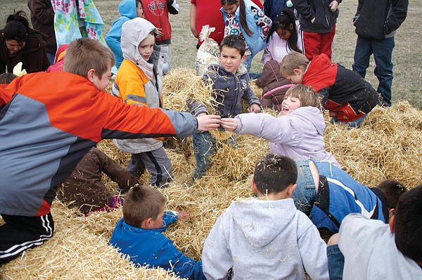 Children search for money in bales of hay Saturday as part of the 5th annual Easter Egg Hunt at Dayton Park.