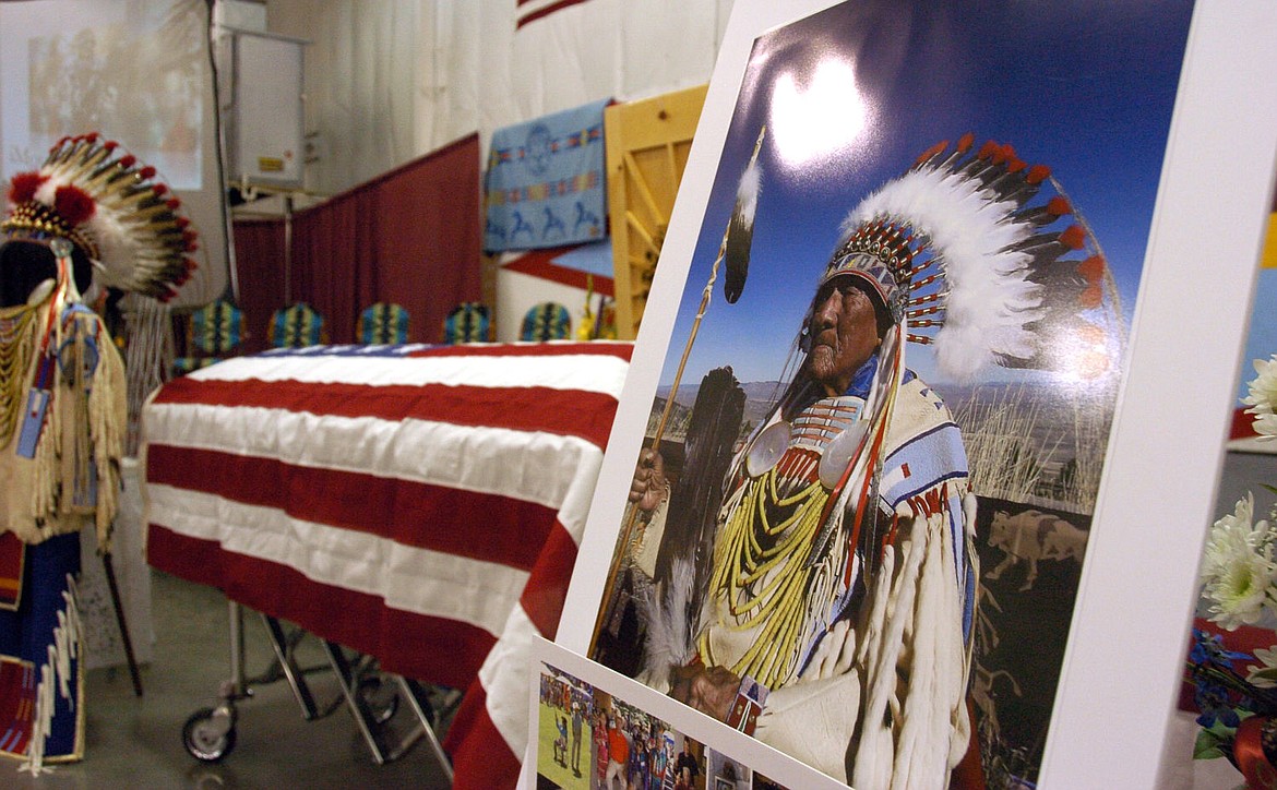 <p>A portrait of Joe Medicine Crow in full headdress stands next to his casket during his funeral service at the Apsaalooke Veterans Cemetery near Crow Agency, Mont., Wednesday, April 6, 2016. Medicine Crow was the Crow Tribe's last surviving war chief and a widely-renowned historian. Medicine Crow, who died April 3, 2016 at 102, spent decades cataloging Crow history and was awarded the Presidential Medal of Freedom by President Barack Obama in 2009. (AP Photo/Matt Brown)</p>