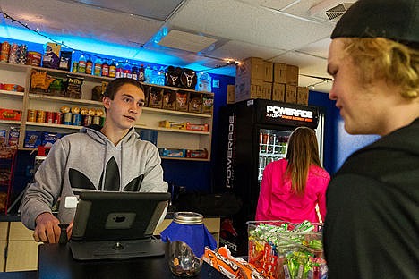 &lt;p&gt;Konar Skindlov helps a customer with his order at the DECA store on Monday at Coeur d&#146;Alene High School. The school-based enterprise was recently gold-certified.&lt;/p&gt;