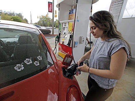 &lt;p&gt;In this Monday photo, Lucy Perez, of Charlotte, N.C., pumps gas at a station in Matthews, N.C. Drivers will see the lowest summer gasoline prices in about 6 years, according to an Energy Department report released Tuesday.&lt;/p&gt;