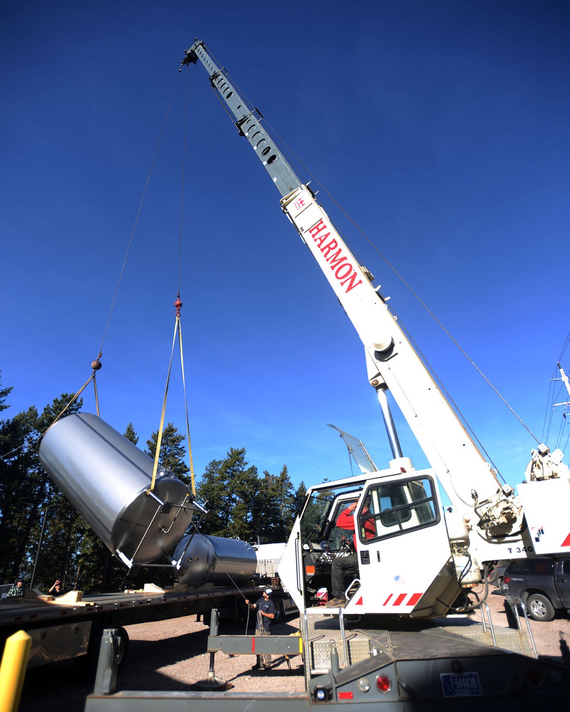 &lt;p&gt;Chuck Harmon of Harmon Crane and Rigging, Inc., hoists the first of two new tanks which were delivered to the Flathead Lake Brewing Co. on Thursday, April 7, in Bigfork. (Brenda Ahearn/Daily Inter Lake)&lt;/p&gt;